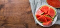 Slices of juicy watermelon on white plate on wooden table Royalty Free Stock Photo