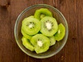 Slices of kiwi fruit on wooden bowl on top Royalty Free Stock Photo