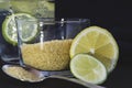 Slices of lemon and lime, cane sugar, spoon, glass