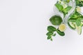 Slices lime, cucumber, leaves mint, ice and transparent cold drink on white wood plank, top view, copy space. Royalty Free Stock Photo