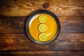 Slices of lime and lemon on yellow and green plates on a wooden surface