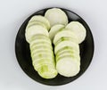Slices of Loofah on a black plate Royalty Free Stock Photo