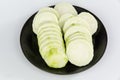 Slices of Loofah on a black plate Royalty Free Stock Photo