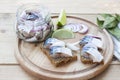 Slices of marinated mackerel with onion in a jar, lime, laurel and bread on wooden board Royalty Free Stock Photo