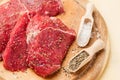 Slices of meat in salt and pepper on a round plate Royalty Free Stock Photo