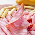 Slices of mortadella and bread sticks Royalty Free Stock Photo