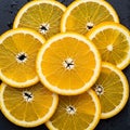 Slices of orange arranged in a circular pattern on a dark surface Royalty Free Stock Photo