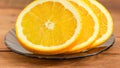 Slices of an orange on a glass saucer closeup Royalty Free Stock Photo