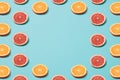 Slices of orange and grapefruit on a blue background. Minimal pattern. Copy space Royalty Free Stock Photo