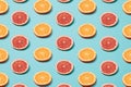 Slices of orange and grapefruit on a blue background. Minimal pattern Royalty Free Stock Photo