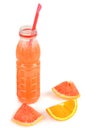 Slices of orange and grapefruit, citrus juice in a bottle isolated on white . Vertical photo Royalty Free Stock Photo