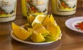 Slices of orange on a saucer with tequila mezcal bottles