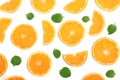 Slices of orange or tangerine with mint leaves isolated on white background. Flat lay, top view. Fruit composition Royalty Free Stock Photo