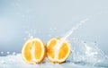 Slices of orange thrown water Royalty Free Stock Photo