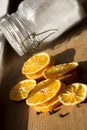 Slices oranges, glass jar with sugar inside, day light shot. Selective focus