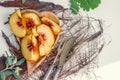 Slices of peaches lie on a plate of olive tree on a white table Royalty Free Stock Photo