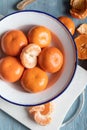 Slices of peeled tangerine in a bowl, top view. Close up of a mandarin orange over white background. Royalty Free Stock Photo