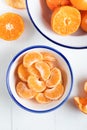 Slices of peeled tangerine in a bowl, top view. Close up of a mandarin orange over white background. Royalty Free Stock Photo