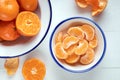 Slices of peeled tangerine in a bowl, top view. Close up of a mandarin orange over white background. Royalty Free Stock Photo