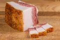 Slices and piece of salted pork fatback on cutting board Royalty Free Stock Photo