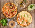 Slices of pizza with different toppings and pitcher of lemonde on wooden table Royalty Free Stock Photo