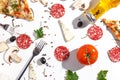 Slices of pizza, ingredients and cutlery on a white background. Top view Royalty Free Stock Photo