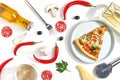 Slices of pizza, ingredients and cutlery on a white background. Top view Royalty Free Stock Photo