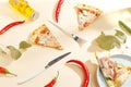 Slices of pizza, ingredients and cutlery on a white background. Top view Royalty Free Stock Photo