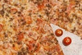 Slices of pizza up close and fresh tomatoes