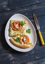 Slices pizza with zucchini, tomatoes, onions and feta cheese on a light ceramic plate on dark wooden background. Royalty Free Stock Photo