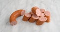 Slices of Polska Kielbasa on a gray marble cutting board.