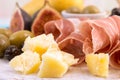 Slices of prosciutto, pieces of cheese, olives and figs Royalty Free Stock Photo