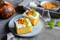Slices of pumpkin cake topped with cream cheese and Sea Buckthorn compote