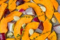 Slices of pumpkin, pieces of red sweet onion, garlic cooked on for baking, spices, fresh thyme Royalty Free Stock Photo