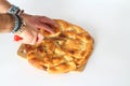 Slices of Ramadan Pita (Ramazan Pidesi) Traditional Turkish bread for holy month Ramadan on white background.