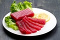 Slices of raw bluefin tuna sashimi on white dish on wood backgr Royalty Free Stock Photo