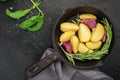 Slices of raw fresh potatoes before cooking with basil, rosemary, butter, garlic and salt for baking in country style