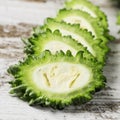 Slices of raw karela on a table