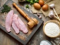 Slices of raw meat schnitzel on a beautiful wooden cutting board Royalty Free Stock Photo