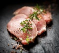 Slices of raw pork loin with the addition of aromatic herbs and spices Royalty Free Stock Photo