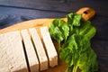 Slices of raw tofu and spinach Royalty Free Stock Photo