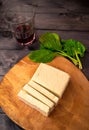 Slices of raw tofu, spinach and wine Royalty Free Stock Photo