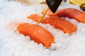 Slices red fish with ice on the counter Royalty Free Stock Photo