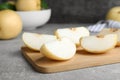 Slices of ripe apple pear on grey table Royalty Free Stock Photo