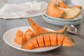 Slices of ripe cantaloupe melon on wooden Royalty Free Stock Photo