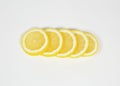 Slices of ripe juicy lemon full of vitamins lie horizontally on top of each other on a white isolated background