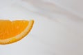 Slices of ripe orange closeup with drops of juice on a white background