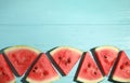 Slices of ripe watermelon on light blue wooden table, flat lay. Space for text Royalty Free Stock Photo