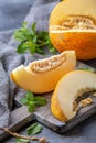 Slices of ripe yellow melon on a wooden board Royalty Free Stock Photo