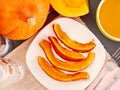 Slices of roast pumpkin on a plate, autumn food